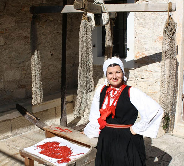 Woman from Zlarin wearing a traditional clothes with coral jewellry